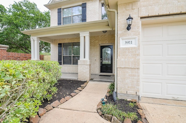 3911 Fallsbrook Ct, Sugar Land, TX 77479 - property entrance featuring an attached garage and a porch