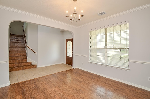 3911 Fallsbrook Ct, Sugar Land, TX 77479 - entryway with stairs, wood finished floors, arched walkways, an inviting chandelier, and visible vents