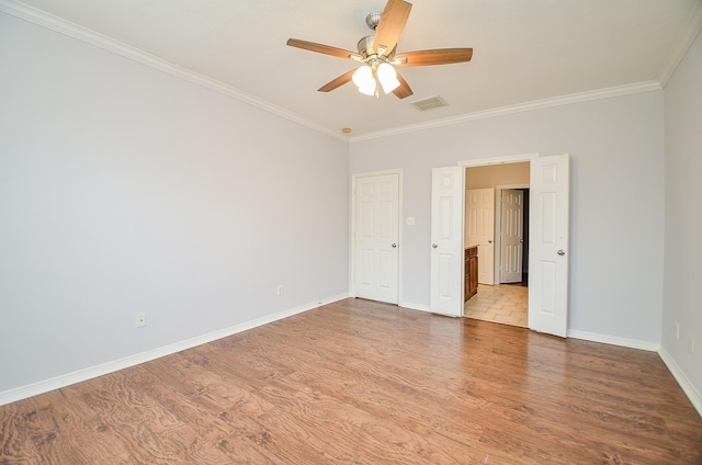 3911 Fallsbrook Ct, Sugar Land, TX 77479 - unfurnished bedroom featuring baseboards, visible vents, a ceiling fan, wood finished floors, and crown molding
