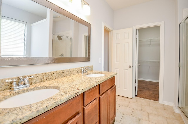 3911 Fallsbrook Ct, Sugar Land, TX 77479 - full bath with a walk in closet, a sink, and a stall shower