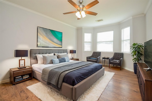 3911 Fallsbrook Ct, Sugar Land, TX 77479 - bedroom with wood finished floors, visible vents, a ceiling fan, crown molding, and baseboards