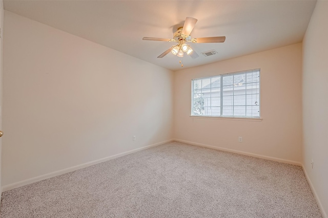 unfurnished room featuring visible vents, carpet flooring, baseboards, and a ceiling fan