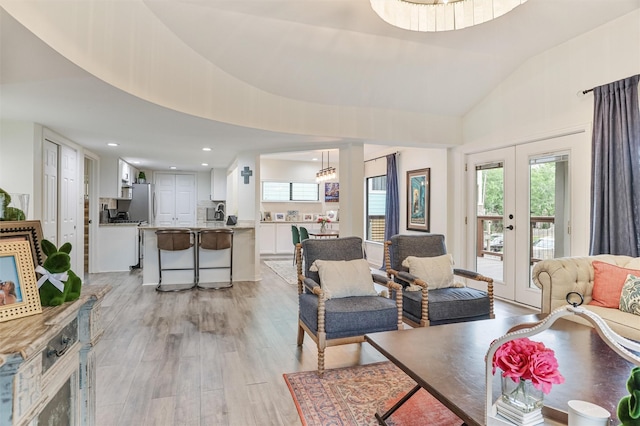 224 Clear Lake Rd, Clear Lake Shores, TX 77565 - living area with high vaulted ceiling, a wealth of natural light, french doors, and light wood finished floors