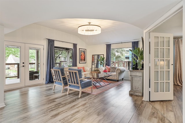 224 Clear Lake Rd, Clear Lake Shores, TX 77565 - living room with lofted ceiling, wood finished floors, a healthy amount of sunlight, french doors, and arched walkways
