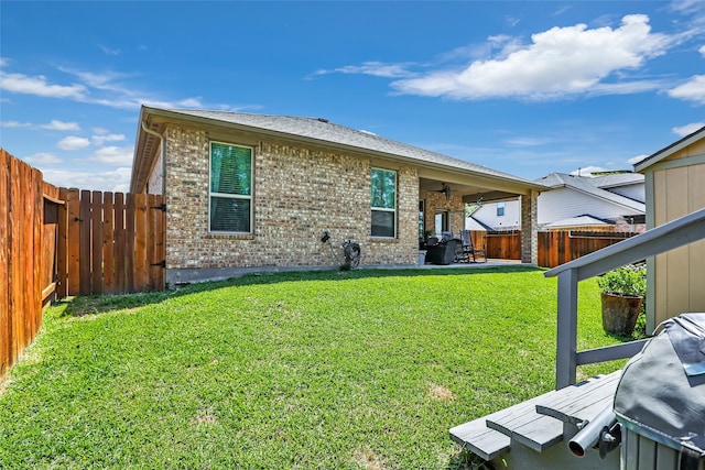 22086 Sun Haven Ln, Porter, TX 77365 - back of property featuring a lawn, a fenced backyard, brick siding, and a patio