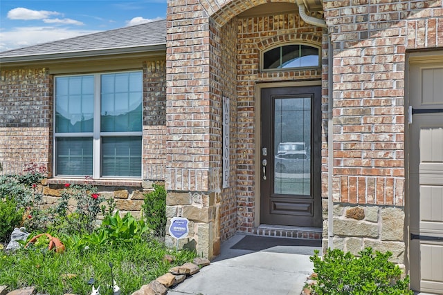 22086 Sun Haven Ln, Porter, TX 77365 - view of exterior entry with stone siding, brick siding, and roof with shingles