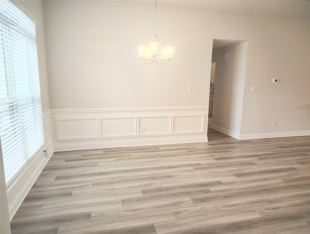2 Gemstone Ct, Angleton, TX 77515 - unfurnished dining area with a chandelier, light wood-style floors, and wainscoting