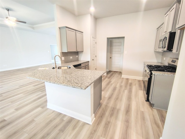 2 Gemstone Ct, Angleton, TX 77515 - kitchen featuring appliances with stainless steel finishes, a sink, gray cabinetry, a ceiling fan, and a peninsula