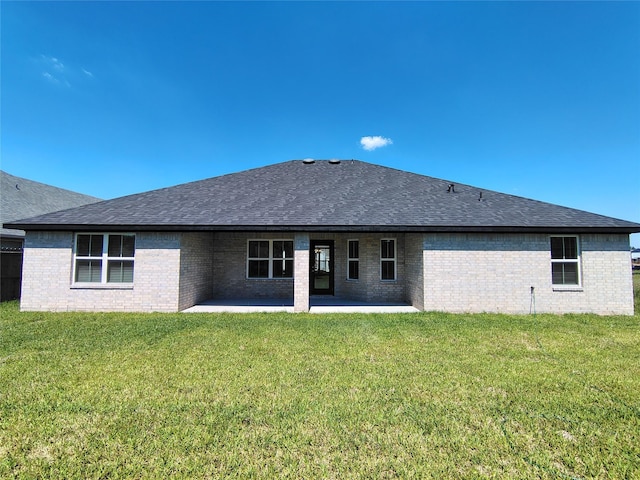 2 Gemstone Ct, Angleton, TX 77515 - rear view of house featuring a patio, roof with shingles, brick siding, and a yard