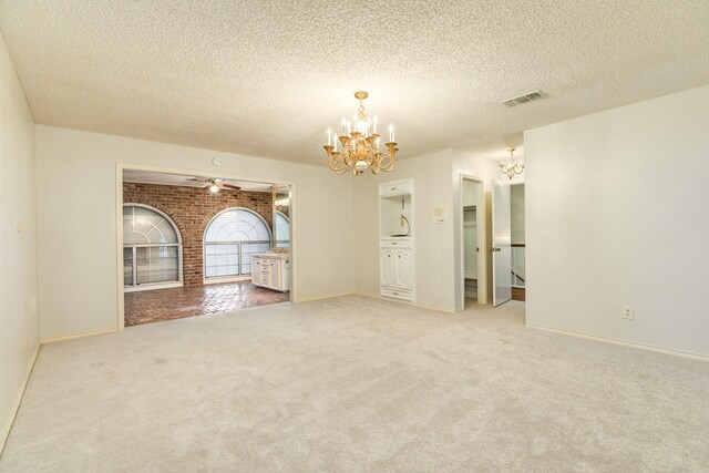 2610 Gerol Ct, Galveston, TX 77551 - carpeted spare room with an inviting chandelier, a textured ceiling, and baseboards