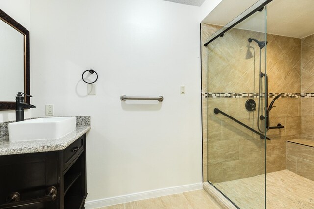 2610 Gerol Ct, Galveston, TX 77551 - full bathroom featuring baseboards, vanity, and a shower stall