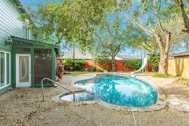 2610 Gerol Ct, Galveston, TX 77551 - view of swimming pool with a fenced in pool, a water slide, a patio, and a fenced backyard