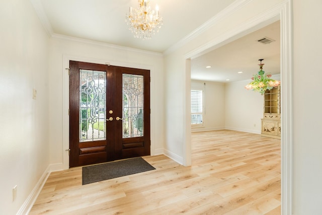 2610 Gerol Ct, Galveston, TX 77551 - foyer entrance with visible vents, french doors, crown molding, light wood-style flooring, and a notable chandelier