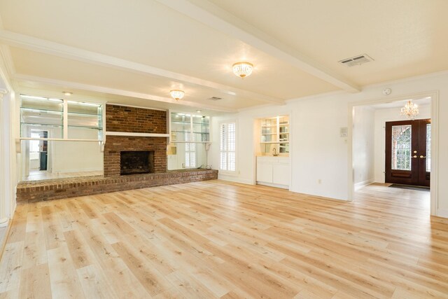 2610 Gerol Ct, Galveston, TX 77551 - unfurnished living room featuring a brick fireplace, wood finished floors, visible vents, and beam ceiling