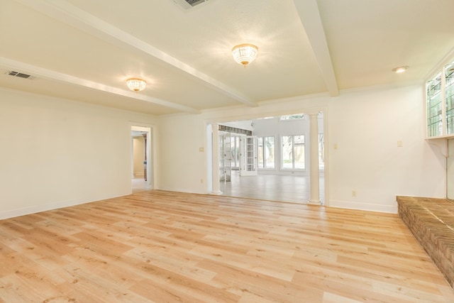 2610 Gerol Ct, Galveston, TX 77551 - unfurnished living room with beamed ceiling, a wealth of natural light, light wood finished floors, and decorative columns