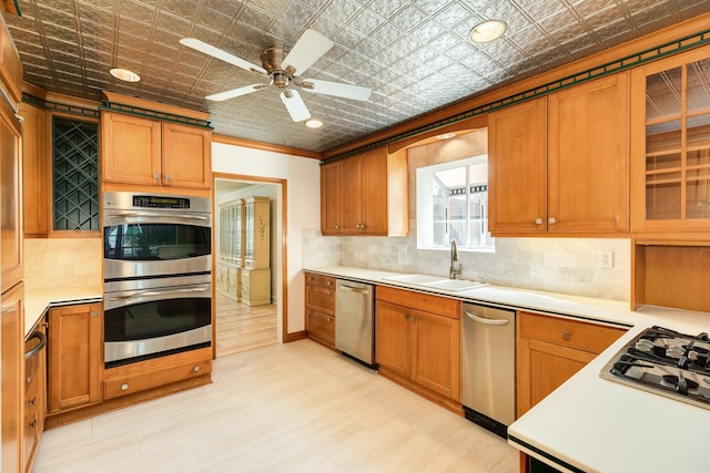 2610 Gerol Ct, Galveston, TX 77551 - kitchen featuring a sink, an ornate ceiling, backsplash, light countertops, and appliances with stainless steel finishes