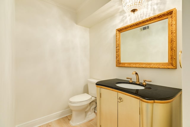 2610 Gerol Ct, Galveston, TX 77551 - bathroom featuring visible vents, toilet, vanity, ornamental molding, and baseboards
