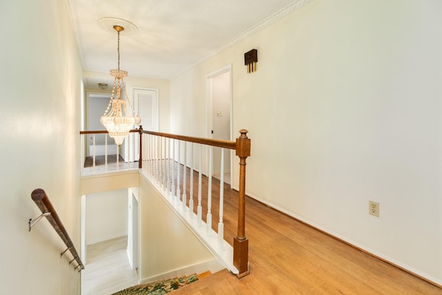 2610 Gerol Ct, Galveston, TX 77551 - stairway with a chandelier, wood finished floors, crown molding, and baseboards
