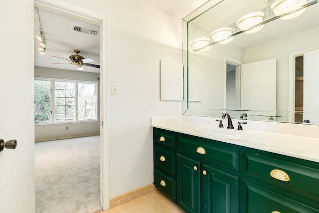 2610 Gerol Ct, Galveston, TX 77551 - bathroom with a ceiling fan, visible vents, a textured ceiling, and vanity