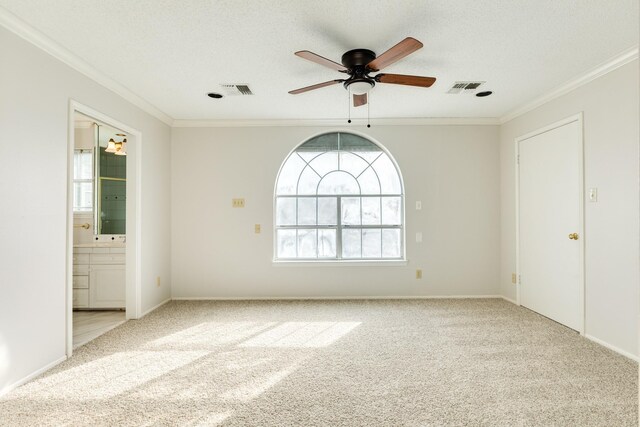 2610 Gerol Ct, Galveston, TX 77551 - carpeted empty room featuring ceiling fan, crown molding, a textured ceiling, and visible vents