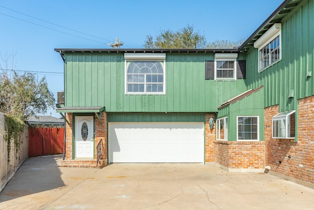 2610 Gerol Ct, Galveston, TX 77551 - view of front of home featuring a garage, fence, brick siding, and concrete driveway