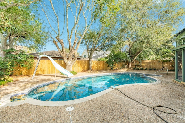 2610 Gerol Ct, Galveston, TX 77551 - view of pool featuring a fenced backyard, a water slide, a fenced in pool, and a patio