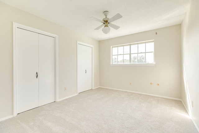 2610 Gerol Ct, Galveston, TX 77551 - unfurnished bedroom featuring baseboards, carpet flooring, and two closets