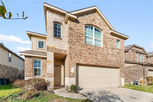 traditional home with concrete driveway, central air condition unit, stone siding, a garage, and brick siding