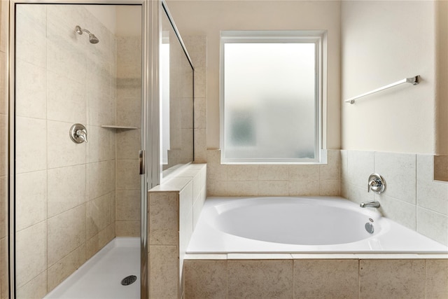 bathroom with a garden tub and a stall shower