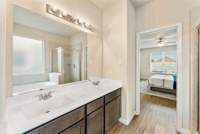 full bath with a shower stall, ensuite bath, wood finished floors, and a sink