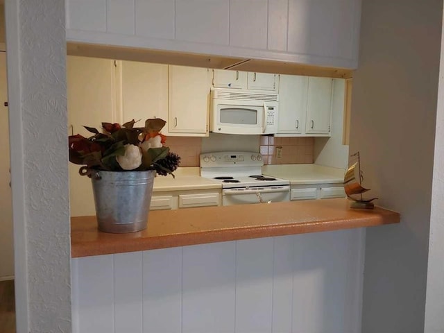 10555 Turtlewood Ct Unit 607, Houston, TX 77072 - kitchen with white cabinets, decorative backsplash, light countertops, and white appliances