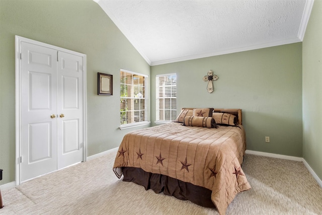 carpeted bedroom featuring lofted ceiling, baseboards, a textured ceiling, and crown molding