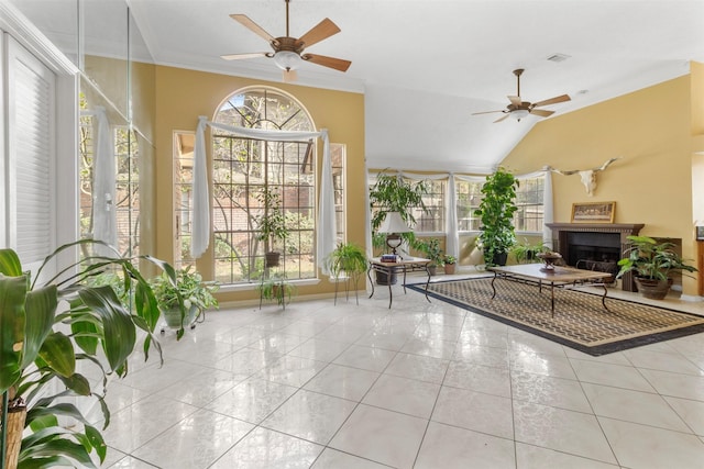 sunroom with a wealth of natural light, crown molding, vaulted ceiling, and visible vents