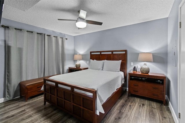 bedroom with a textured ceiling, wood finished floors, ceiling fan, and baseboards
