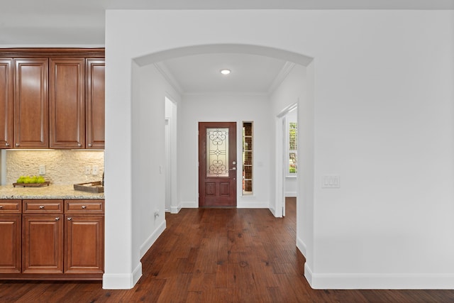 2939 Persimmon Grv, Richmond, TX 77469 - entryway with arched walkways, dark wood finished floors, baseboards, ornamental molding, and recessed lighting