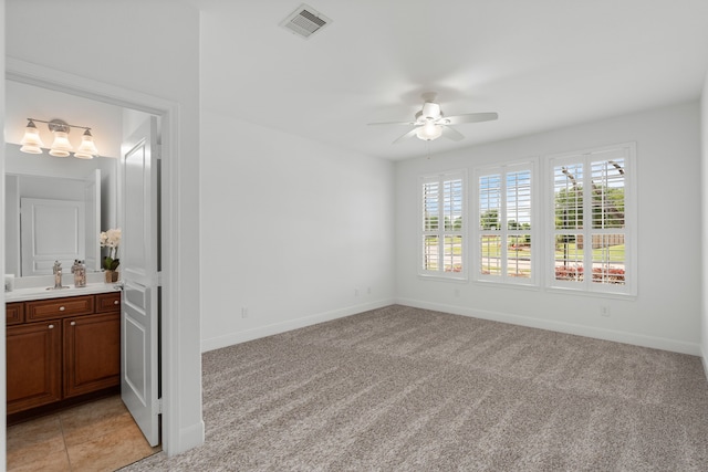 2939 Persimmon Grv, Richmond, TX 77469 - spare room featuring a ceiling fan, baseboards, light colored carpet, and a sink