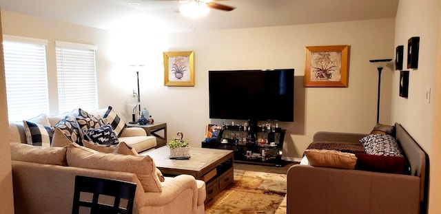 living area with a ceiling fan and light wood-style floors