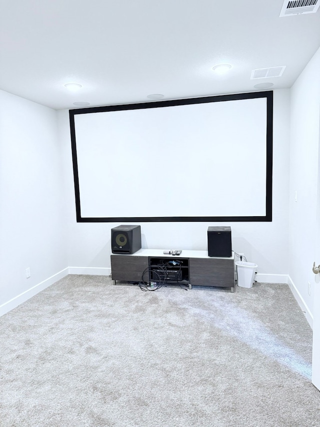 carpeted cinema room featuring baseboards and visible vents