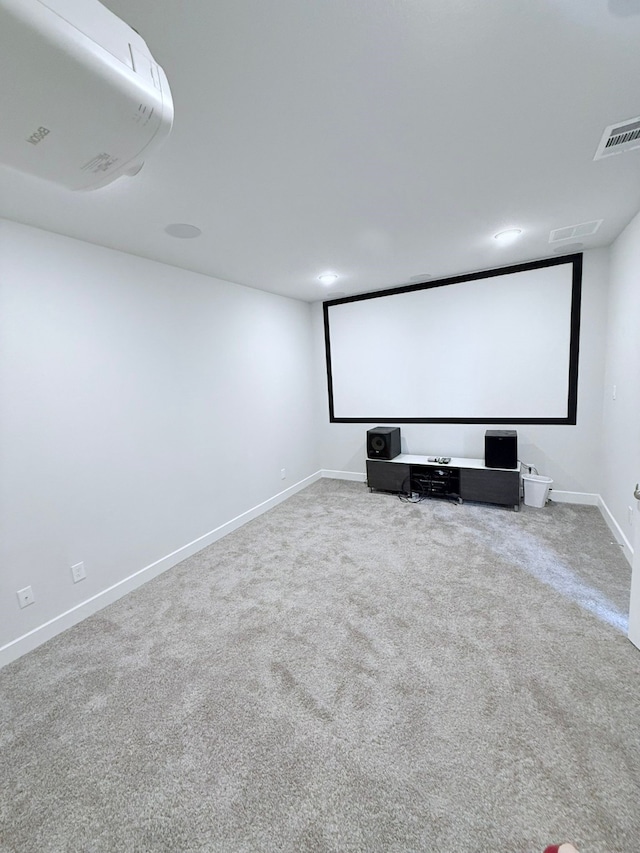 carpeted cinema room featuring baseboards and visible vents