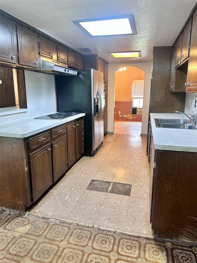 597 County Road 605, Angleton, TX 77515 - kitchen with dark brown cabinets, electric stovetop, under cabinet range hood, and a sink