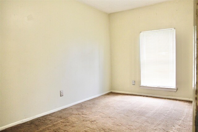 597 County Road 605, Angleton, TX 77515 - spare room featuring carpet flooring and baseboards