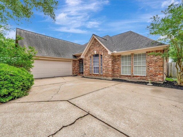 2806 Village Dl, Houston, TX 77059 - view of front of house featuring a shingled roof, brick siding, driveway, and an attached garage