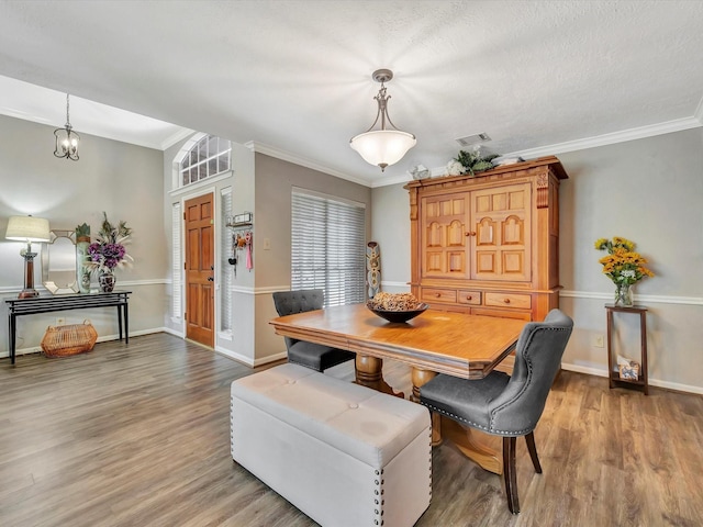 2806 Village Dl, Houston, TX 77059 - dining room with wood finished floors, ornamental molding, baseboards, and a chandelier