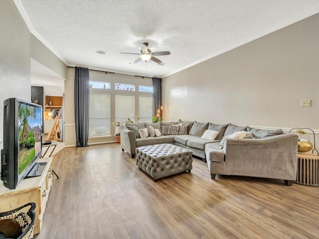 2806 Village Dl, Houston, TX 77059 - living room featuring ceiling fan, ornamental molding, wood finished floors, and a textured ceiling