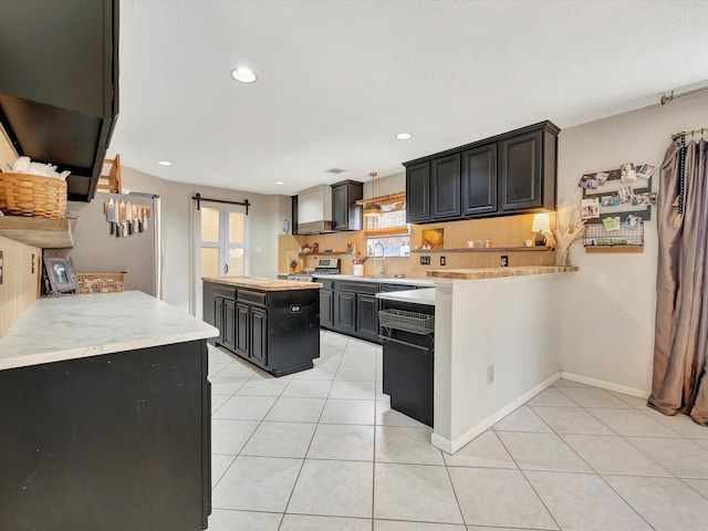 2806 Village Dl, Houston, TX 77059 - kitchen with light countertops, dishwashing machine, a kitchen island, light tile patterned floors, and recessed lighting