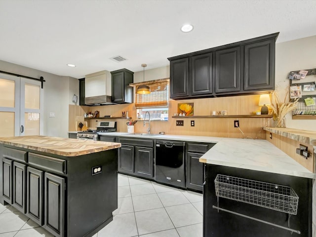 kitchen with a sink, visible vents, dark cabinetry, dishwasher, and stainless steel gas stove