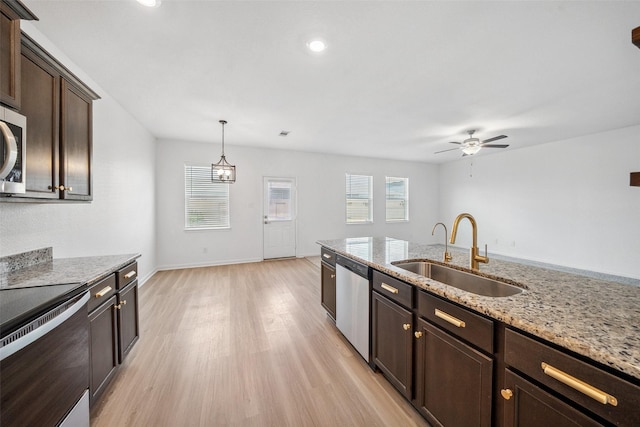 kitchen featuring a sink, ceiling fan, dark brown cabinetry, light wood finished floors, and appliances with stainless steel finishes