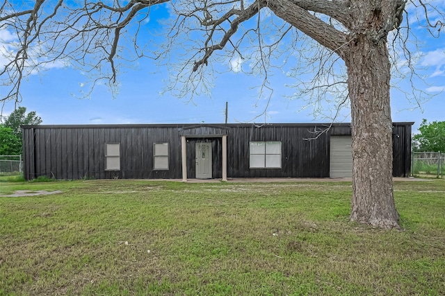 view of outbuilding featuring fence