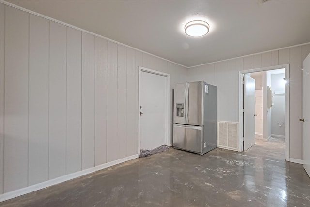 interior space featuring visible vents, concrete floors, and ornamental molding
