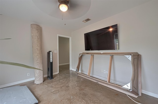 unfurnished room with baseboards, visible vents, concrete flooring, and ceiling fan